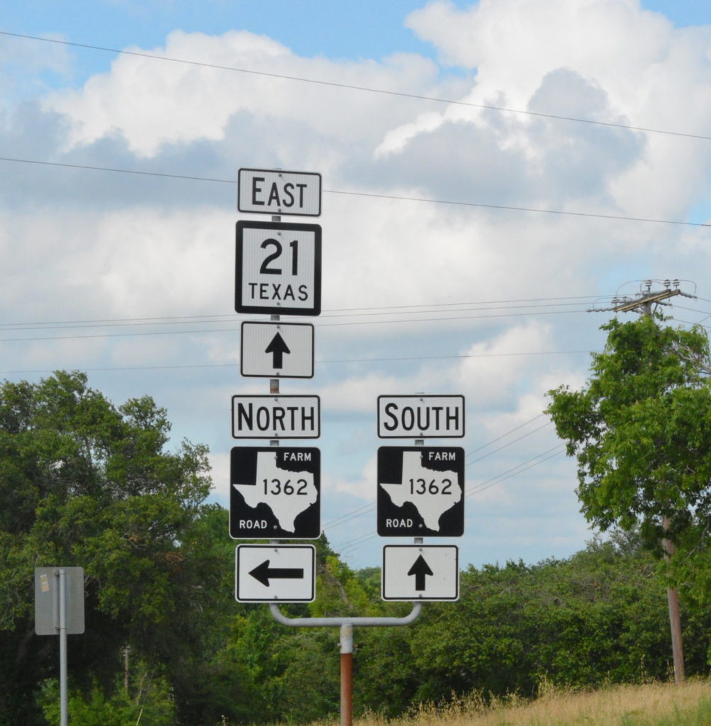 Three highway signs in Texas indicating East Texas highway 21 and North and South Farm Road 1362 directing to various communities.