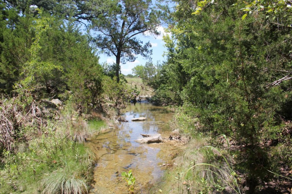 Part of the Lampasas River watershed; a shallow river flanked by trees and brush. A septic system repair and replacement program for residents in the Lampasas River watershed  area will improve and maintain water quality.