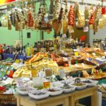 A variety of Italian food products in a stall, some hanging from the top