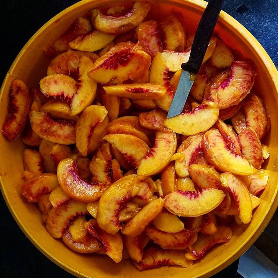 Peaches peeled and cut in a large bowl. 