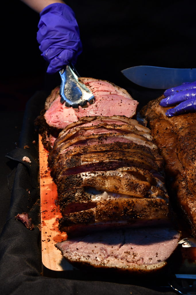 prime rib being served with gloved hands during the Beef Cattle Short Course dinner