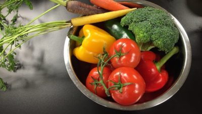 vegetables- tomatoes, carrots, broccoli, belle peppers- in a bowl