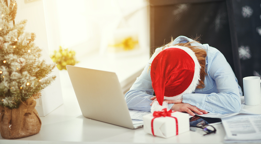 Stressed out woman at computer doing holiday shopping  