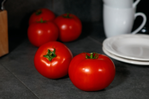5 Red Snapper tomatoes sit on tile table. Red Snapper tomato selected as AgriLife's 'rodeo tomato'