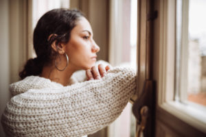 woman looking out the window
