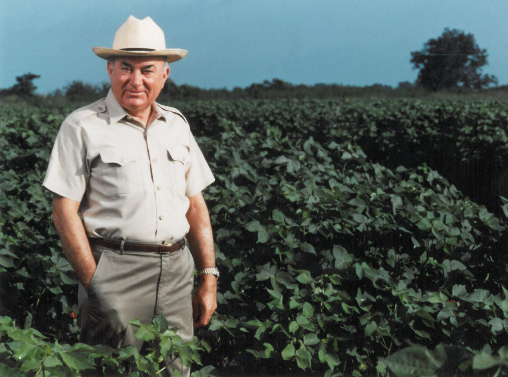 Perry Adkisson standing in cotton fields