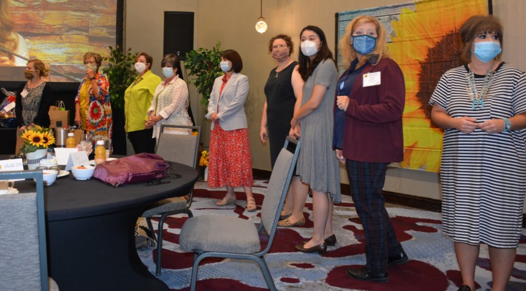 line of ladies with masks on as they prepare for awards banquet