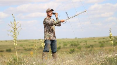 Male wildlife student uses technology to track wildlife.