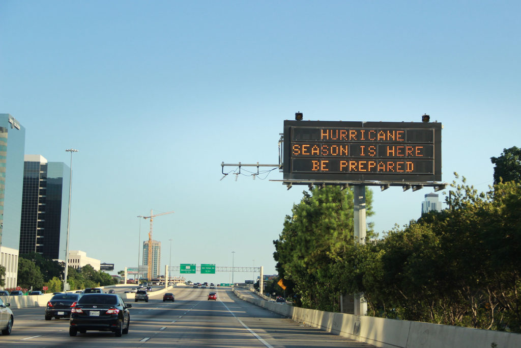 A Houston highway scene with the large digital sign reading Hurricane Season is Here Be Prepared