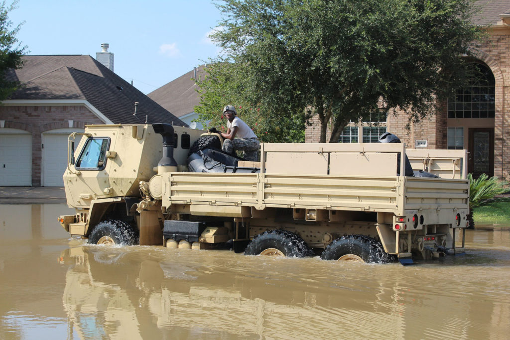 A military vehicle moves through the flooded streets after Hurricane Harvey.