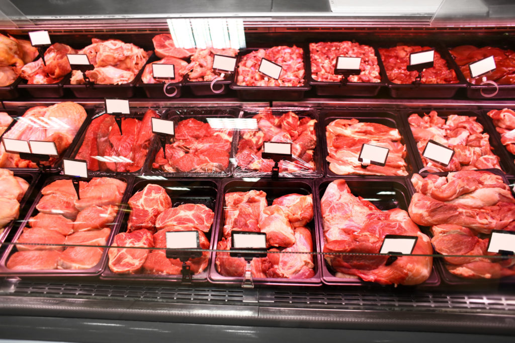 Refrigerated display case with fresh meat in supermarket
