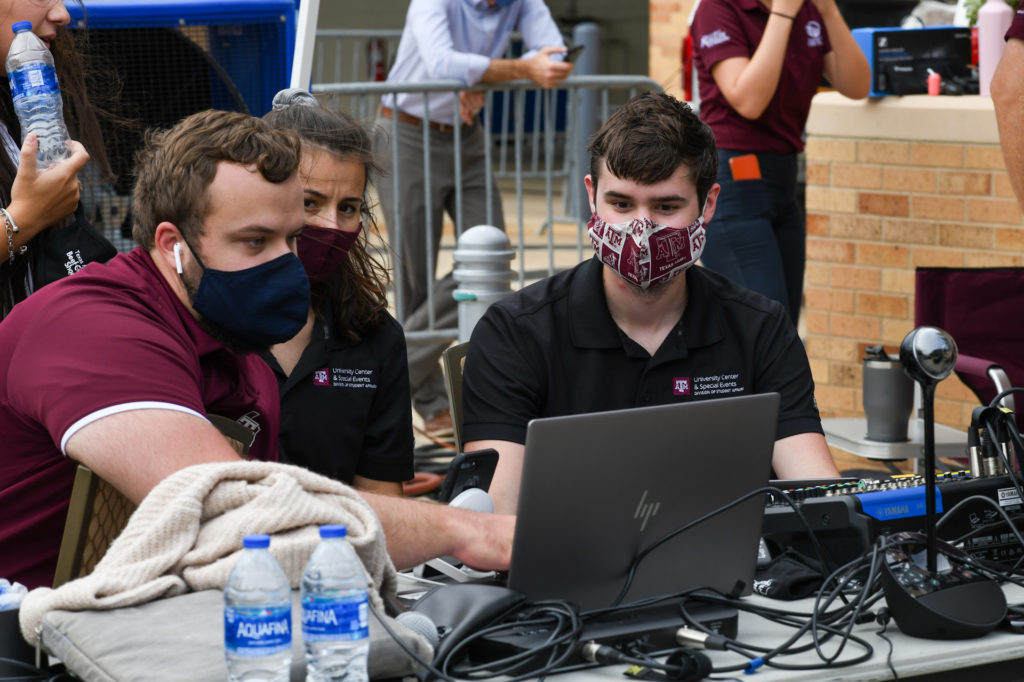 Three masked individuals work on laptops with microphones during the Beef Cattle Short Course.