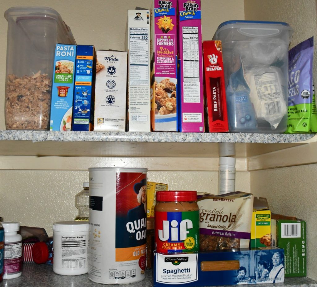 pantry full of cereal boxes, peanut butter, oats and granola.