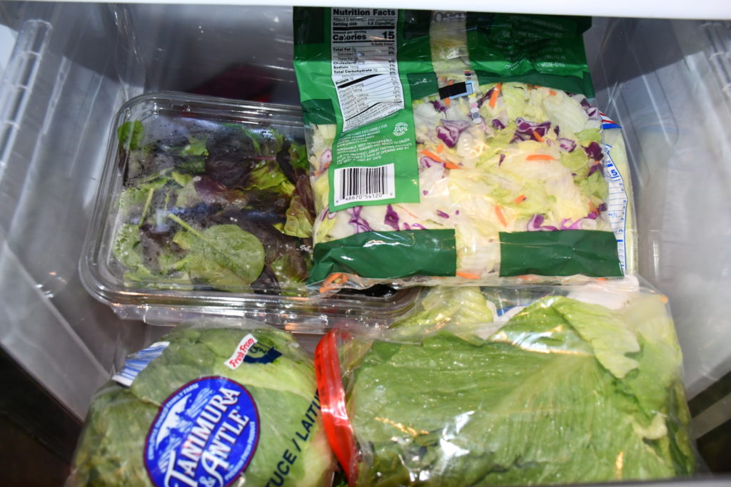 AgriLife photo of various salad greens packaged for storage in crisper drawer of refrigerator