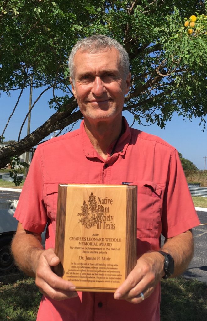 Dr. James Muir holding his award from the Native Plants Society of Texas