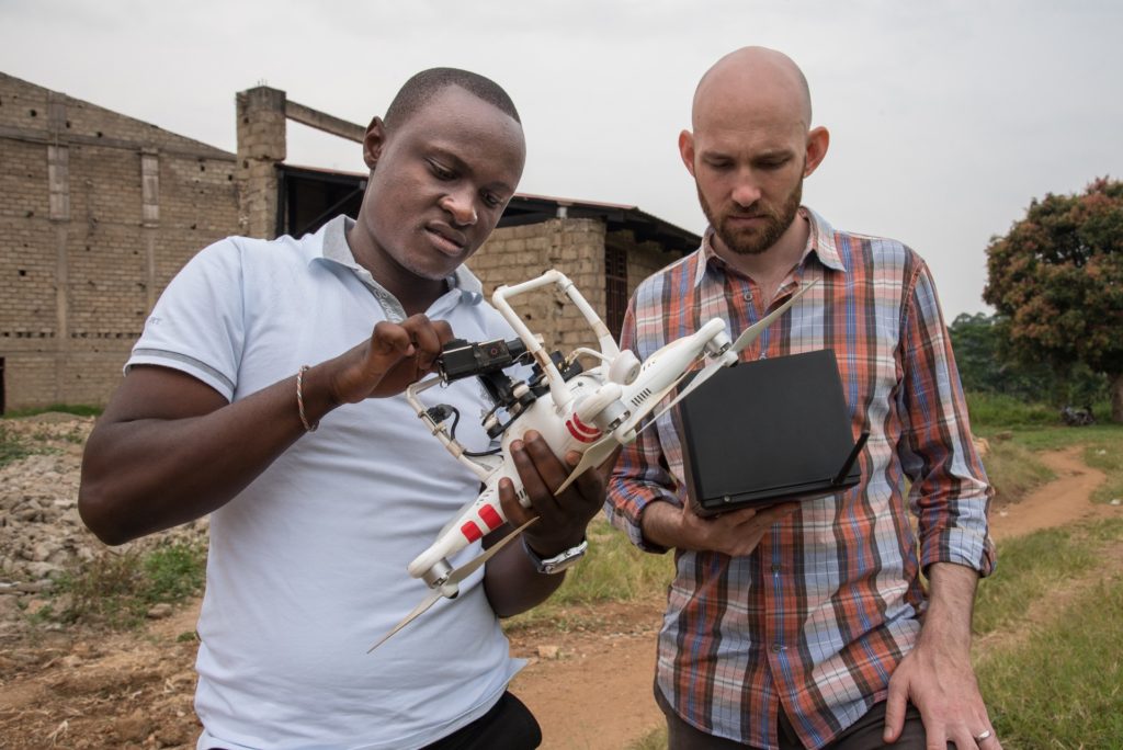 Sharing the Land team members preparing a drone for GPS mapping