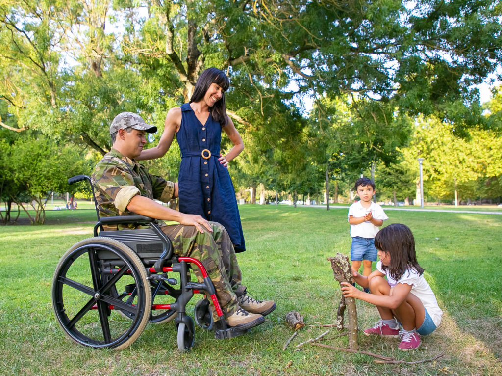 Family in the park with soldier in a wheelchair