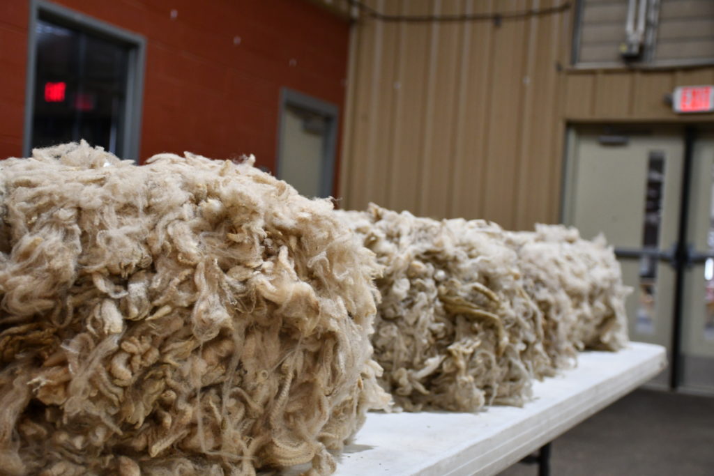 Three piles of wool on a table