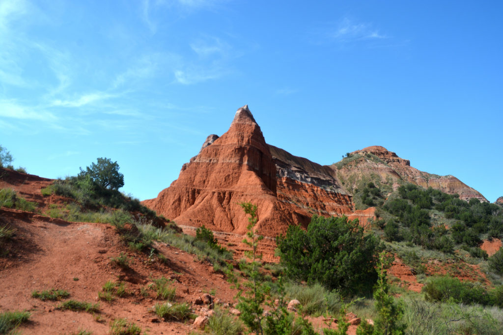 Scenic shot of a hiking trail through the red clay formations in the Palo Duro Canyon In Texas