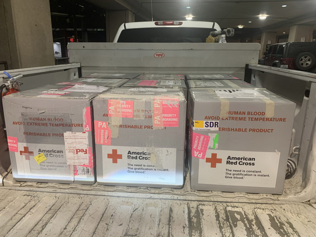 Bed of pickup truck filled with boxes of lifesaving, donated blood.