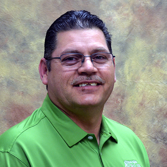 Head shot of a man in a bright green shirt - Lupe Garcia.