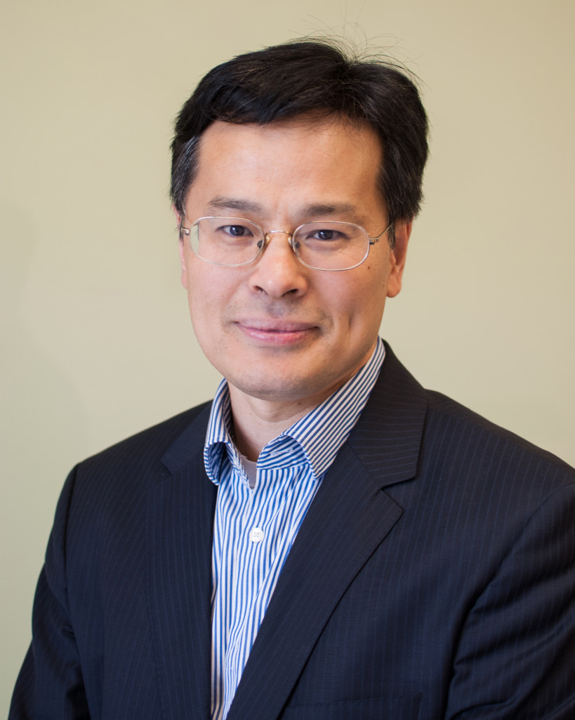 A man, Shaodong Guo, poses for a studio photo - he is a new Presidential Impact Fellow.