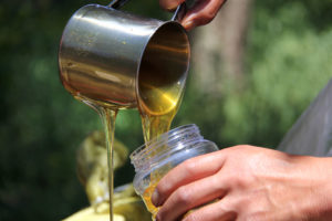 Texas honey being poured into jar. 