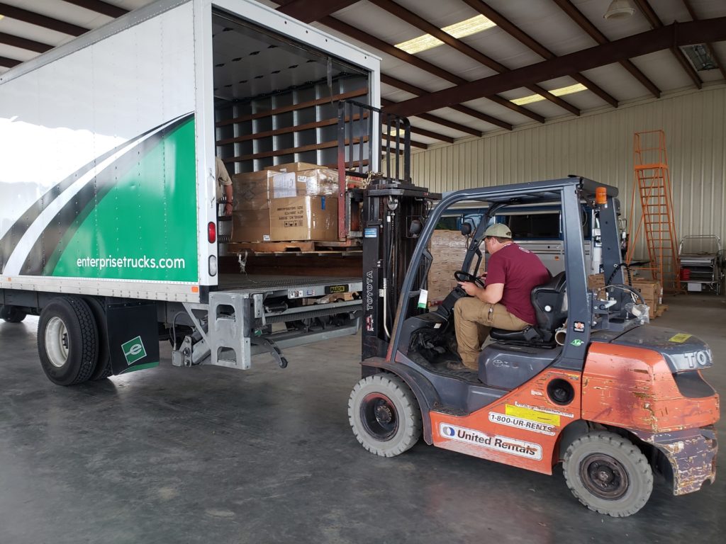 DAR team member Asa Jillson loading truck with disaster relief supplies