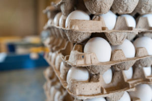 A stack of eggs in cartons 