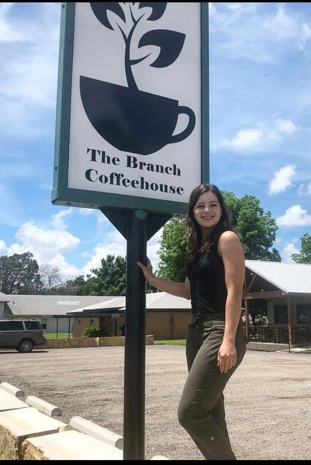 One of the entrepreneurs, Maggi Branch Awalt stands next to  The Branch Coffeehouse sign