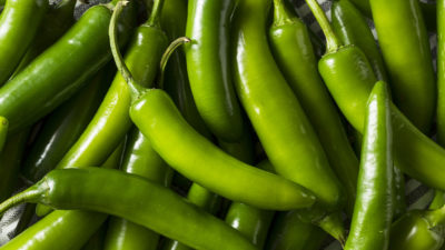 many green peppers on a tablecloth
