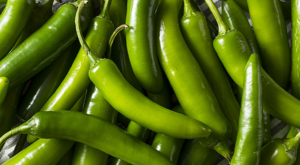many green peppers on a tablecloth