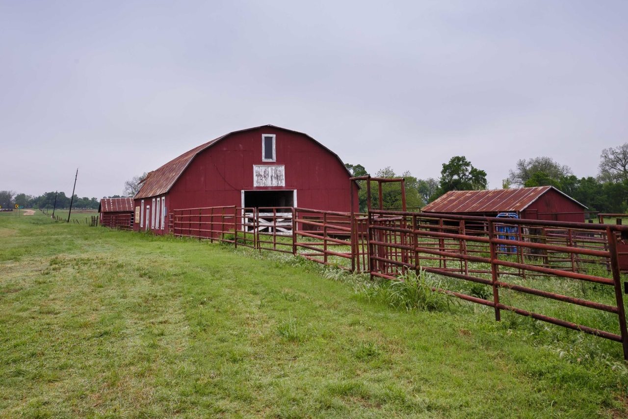 A red barn sits in a green pasture, it is in the Big Elm Creek Watershed area