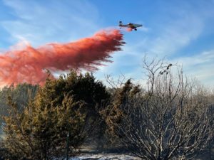 As wildfire potential increases, air tankers stand ready. Air tanker dropping fuel retardent. 
