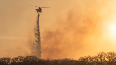 helicopter drops fire retardant over Ramsey Fire