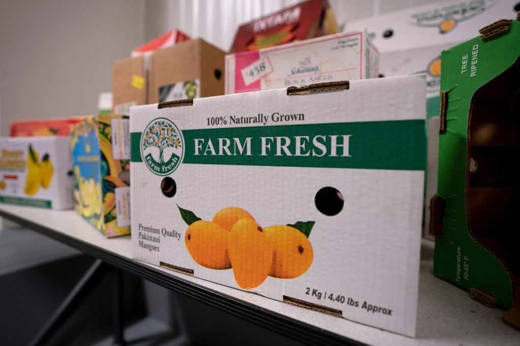 Boxes of mangos marked Farm Fresh at eBeam center