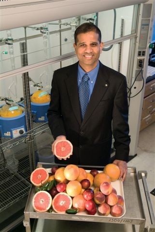 Bhimu Patil with variety of fruits he is researching