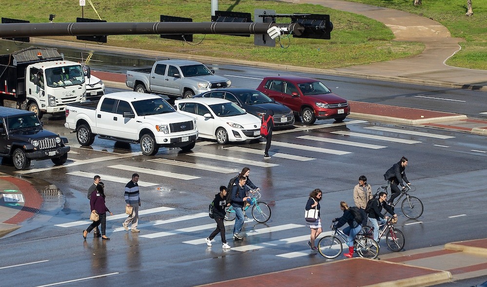Pedestrians and bicyclists at busy crosswalk
