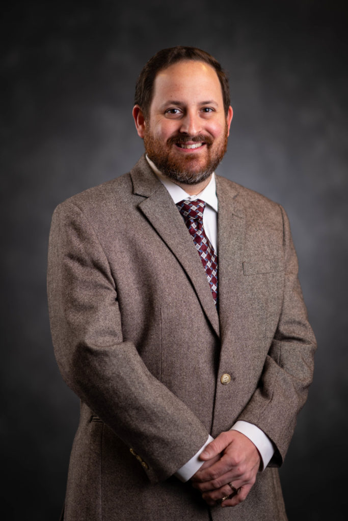 A bearded man in a brown suit - Outstanding Early Career recipient Jonathan A. Cammack, Ph.D.
