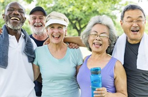 A group of older Americans or seniors enjoy the outdoors with smiles on their faces