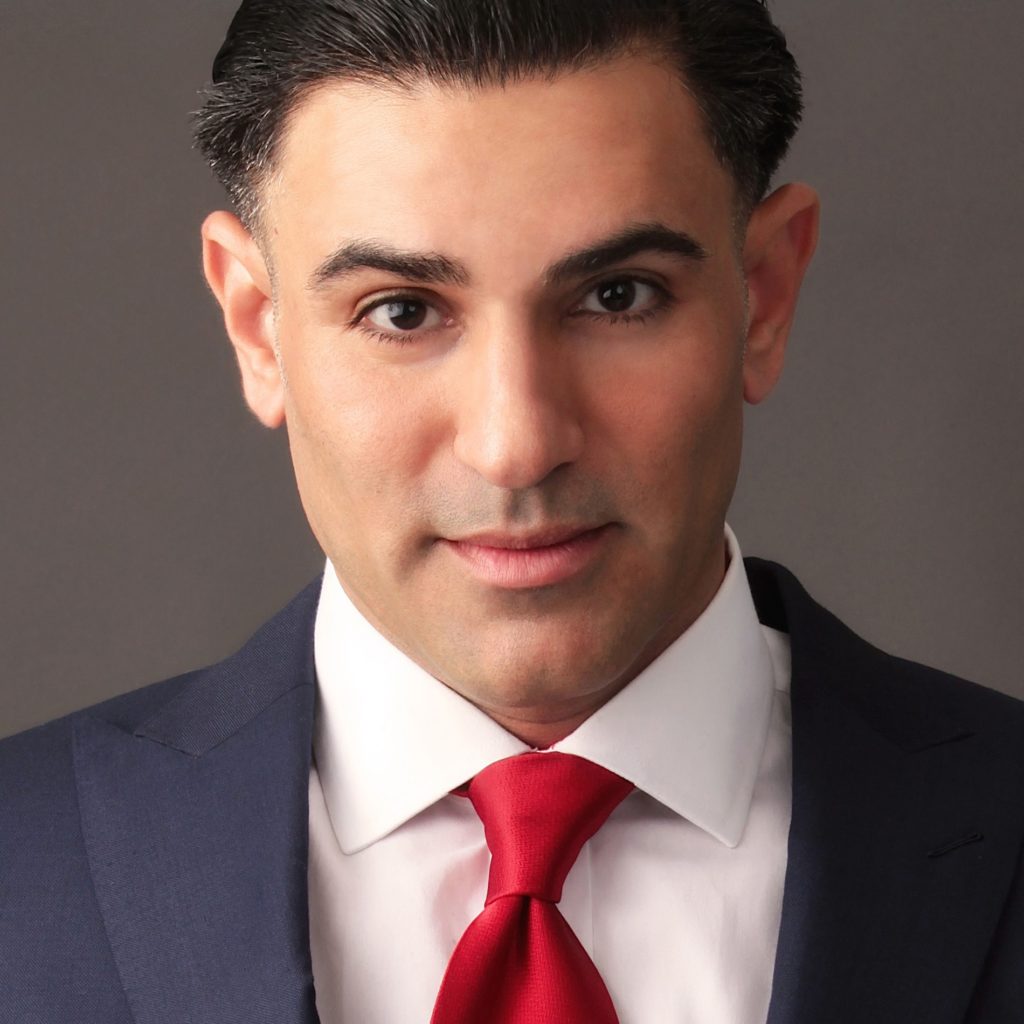 The head shot of a man, Julian Gomez, in a suit and tie.