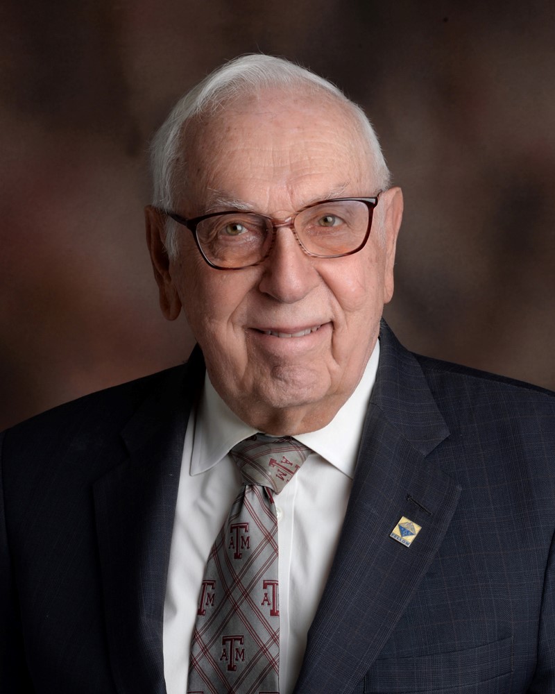 An older man with white hair in a suit and tie - Outstanding Alumni Award recipient Charles H. "Charlie" Whiteside '53, Ph.D.