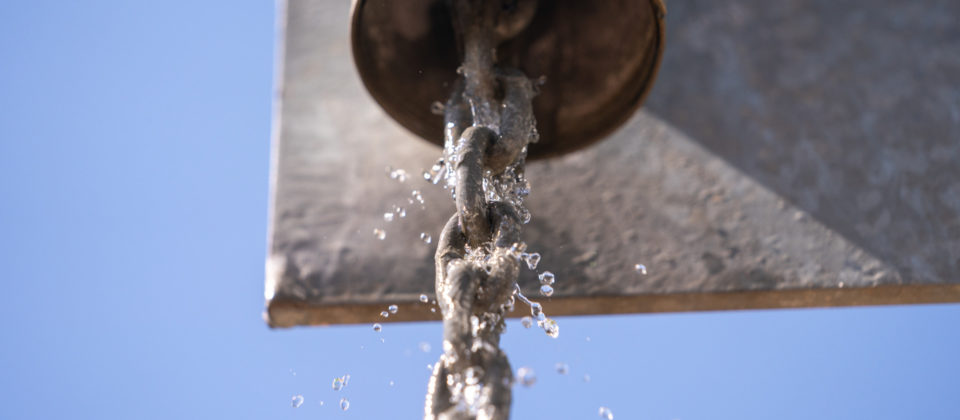 Water falling down rainwater harvesting chain