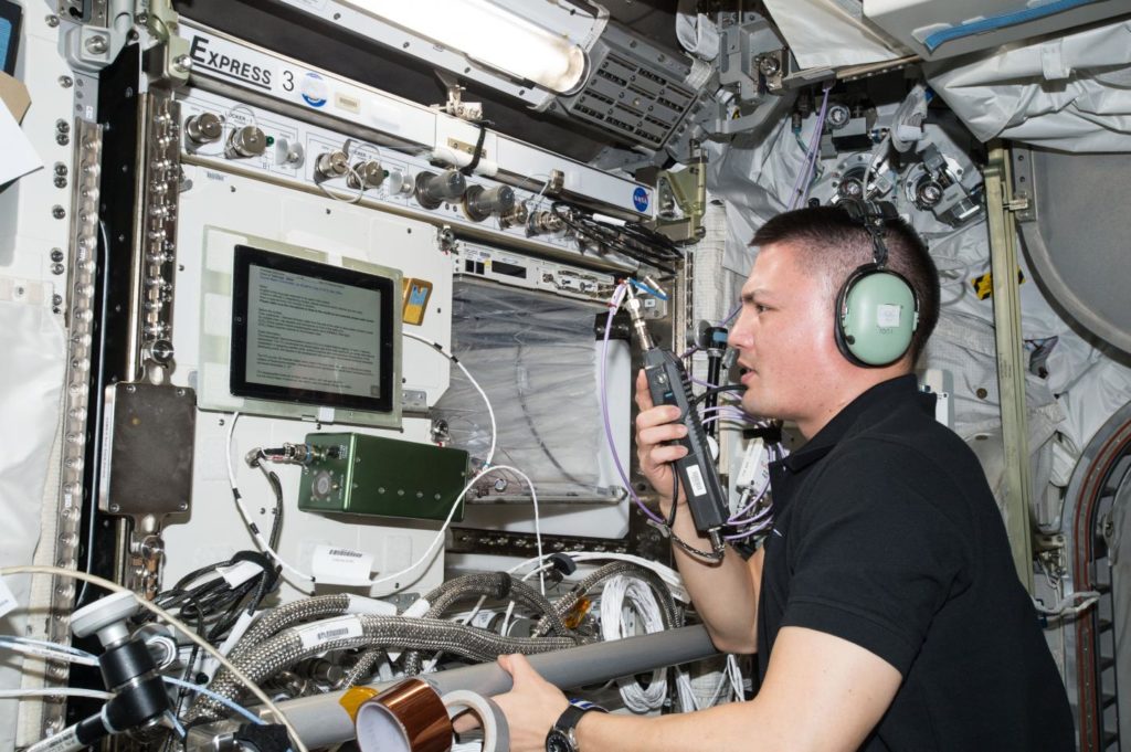 Texas Master Naturalist Kjell Lindgren sitting at communications center on the International Space Station 