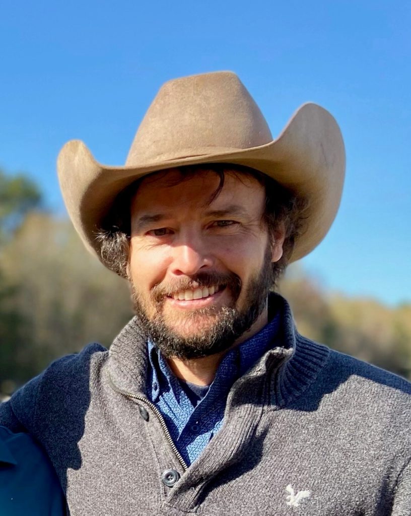 A man in a cowboy hat, Dustin Law, earns research honors