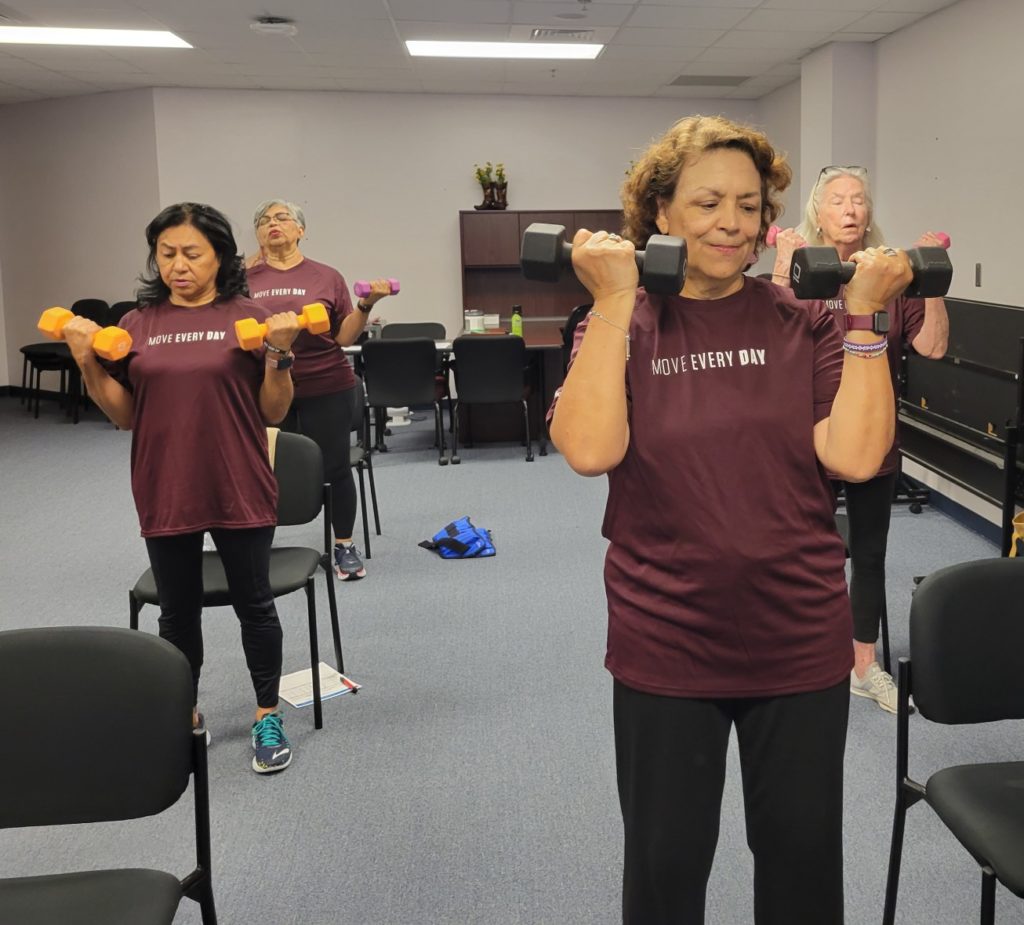 Women curling hand weights during HealthyPeople Healthy Bodies progam