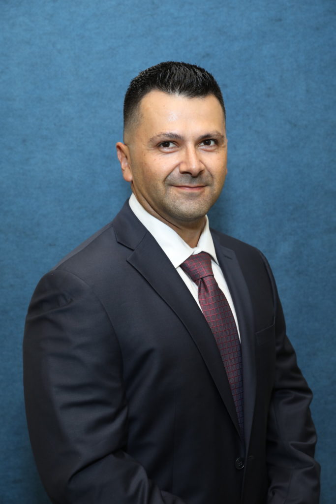 a Hispanic man in a suit and tie