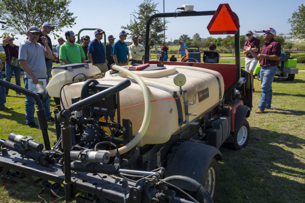 A  piece of turfgrass maintenance equipment with a large tank and spray unit on it