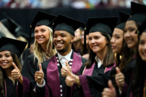 students in caps and gowns awarded degrees as they graduate from the Texas A&M College of Agriculture and Life Sciences