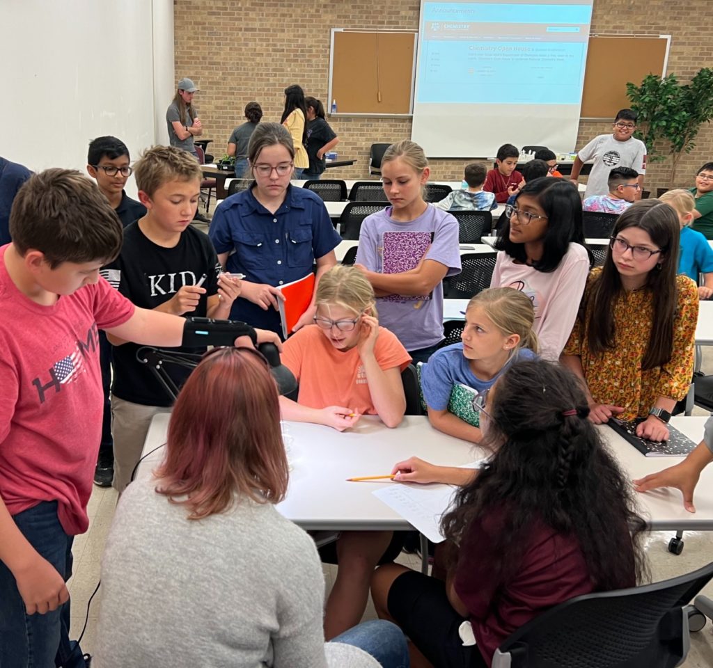 Groups of students participating in the STEM program gather around tables at the Texas A&M AgriLife Research and Extension Center in Uvalde.